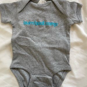6 month Burn Boot Camp onesie. New without tags, never worn